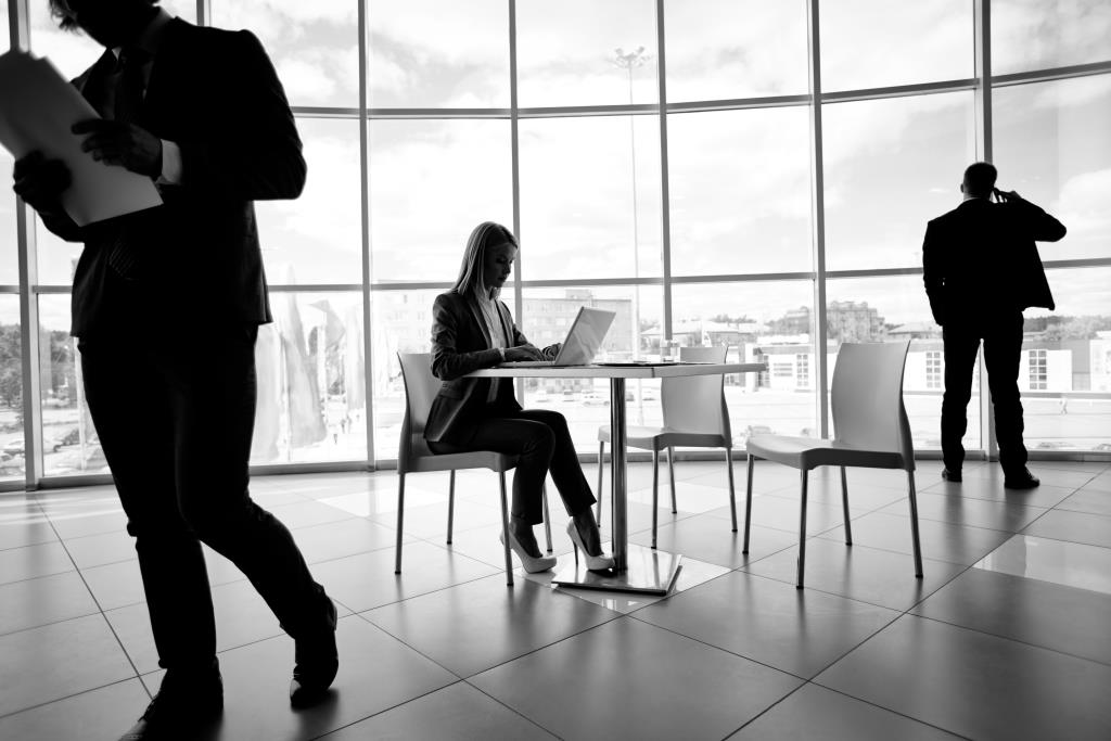 Two businessmen and secretary working in office